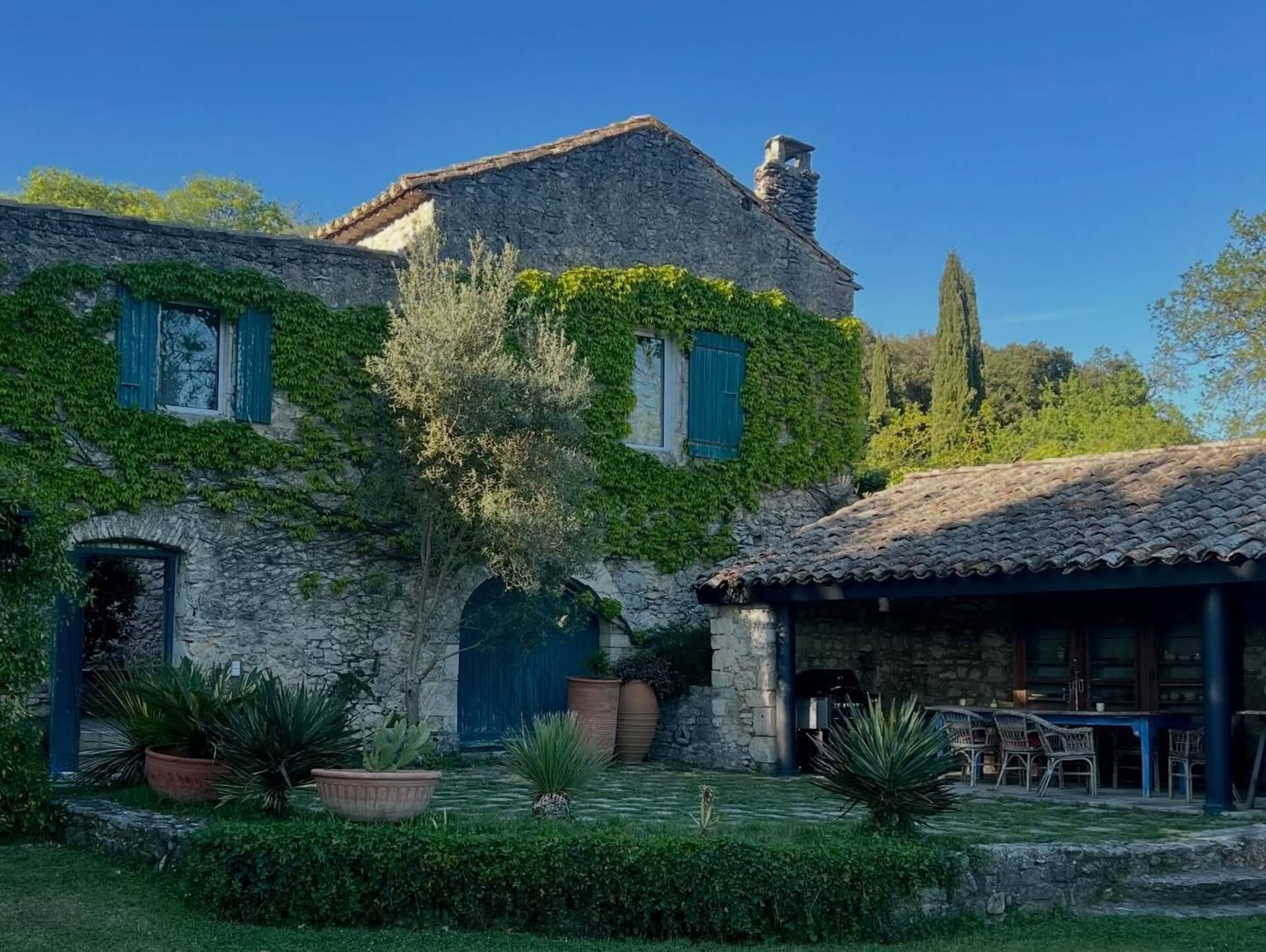 Façade en pierre du Hameau de Beth couverte de vigne vierge